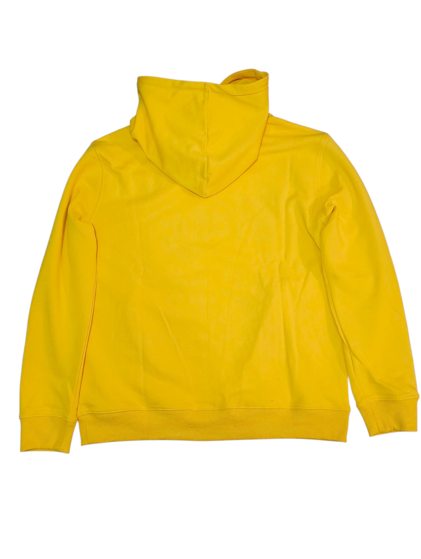 A woman with curly hair walks confidently down a tree-lined sidewalk on a sunny autumn day, wearing a J-clothing premium cotton yellow pullover hoodie and classic blue jeans that elevate her streetwear style.