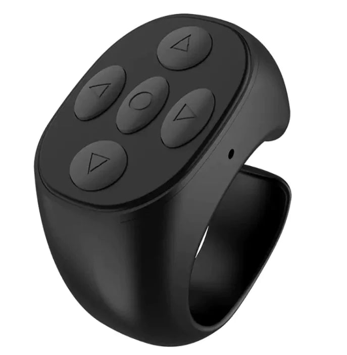 The Jstoremart black silicone ring features a remote control surface with five buttons in a circular pattern. With universal compatibility, it serves as an ideal Bluetooth remote for various devices.