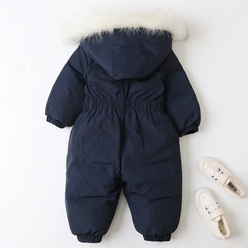 Jstoremart's pink toddler snowsuit, featuring a fur-trimmed hood, elastic cuffs, and waist, is displayed against a white background. Next to it are cozy off-white children's winter shoes with laces from Jstoremart, completing a perfect ensemble for snowy adventures.