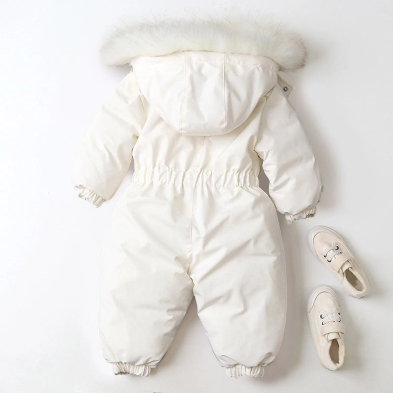 Jstoremart's pink toddler snowsuit, featuring a fur-trimmed hood, elastic cuffs, and waist, is displayed against a white background. Next to it are cozy off-white children's winter shoes with laces from Jstoremart, completing a perfect ensemble for snowy adventures.