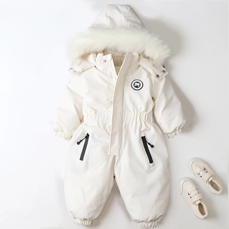 Jstoremart's pink toddler snowsuit, featuring a fur-trimmed hood, elastic cuffs, and waist, is displayed against a white background. Next to it are cozy off-white children's winter shoes with laces from Jstoremart, completing a perfect ensemble for snowy adventures.