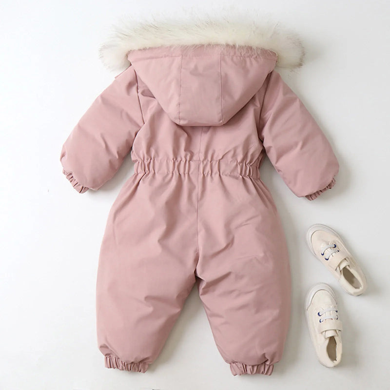 Jstoremart's pink toddler snowsuit, featuring a fur-trimmed hood, elastic cuffs, and waist, is displayed against a white background. Next to it are cozy off-white children's winter shoes with laces from Jstoremart, completing a perfect ensemble for snowy adventures.